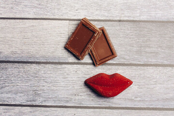 sweets milk chocolate red lips marmalade meal wooden background