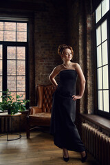 Red-haired girl in loft interior retro style