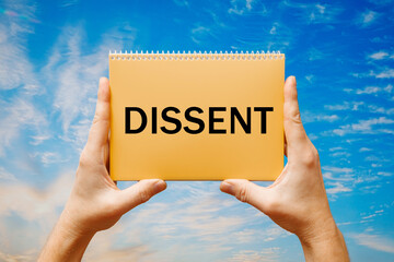 Man holding a card with text DISSENT