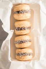 Four typical Argentine alfajores, made from dulce de leche and coconut, In a  box 