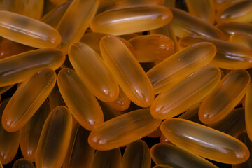 pile of omega 3 and vitamin d capsules