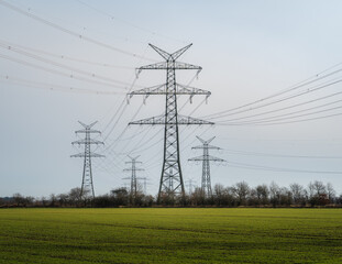 Power mast for high voltage electricity with cables in nice landscape