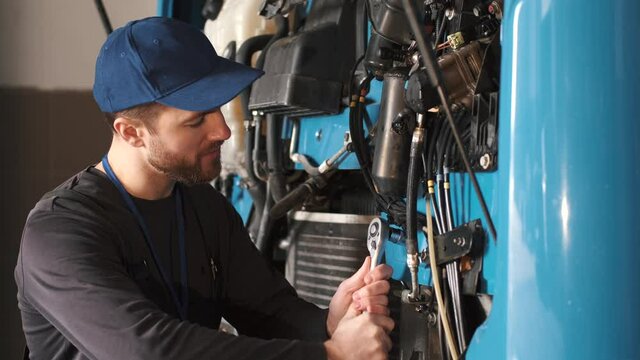 a mechanic is doing a checkup and fixing the truck for it to run