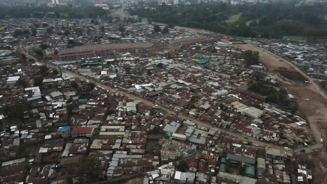 Kibera Slum in Twilight. Aerial View of Poor Residential Neighborhood of Nairobi Kenya, Dirt Road and Buildings Without Electricity