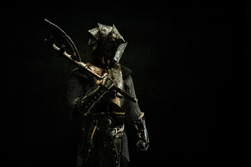 Portrait of a medieval fighter in armor, in profile, an ax on his shoulder - obrazy, fototapety, plakaty