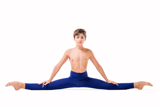 A teenage ballet dancer poses in blue skin-tight tights, barefoot, isolated against a white background.
