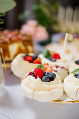 Mini Pavlova dessert on a candy bar, wedding buffet table