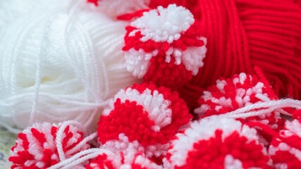 Close up red and white yarn strains of pompoms balls as martenitsa - bulgarian folklore tradition...