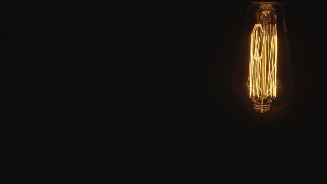 Żarówka Edisona, ozdobna żarówka na ciemnym tle 