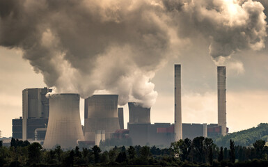Industrial brown coal power plant chimney smokestack emission.
