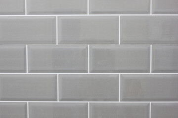 The texture of the black tile wall. Background of black tiled wall. Rectangular tile.