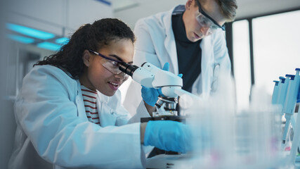 Modern Medical Research Laboratory: Portrait of Black and Caucasian Young Scientists Using...