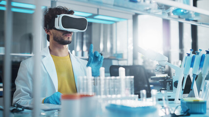 Futuristic Medical Research Laboratory: Research Scientist Wearing Virtual Reality Headset, Does Augmented Reality Research Using Smart Gestures. Big Data AI Biotechnology Research in Progress