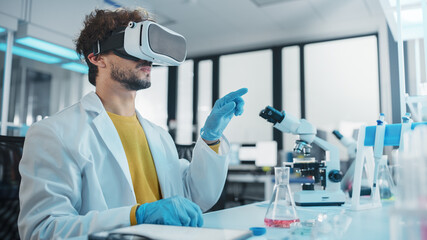 Futuristic Medical Research Laboratory: Research Scientist Wearing Virtual Reality Headset, Does Augmented Reality Research Using Smart Gestures. Big Data AI Biotechnology Research in Progress