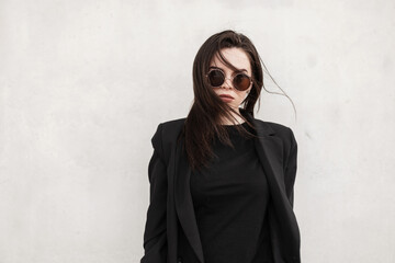 American stylish young woman with brown hair with sexy lips in fashionable round sunglasses in...