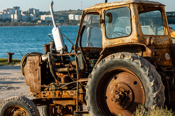 Fototapeta premium An Old rusty abandoned tractor in Crimea.