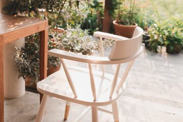 Wood white chair and wooden table in garden on green nature  background.