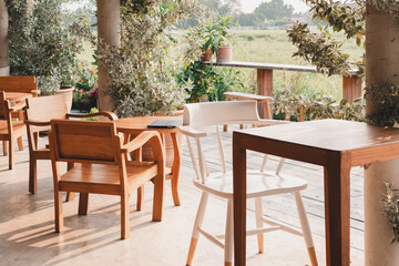Wood white chairs and wooden table in garden on green nature  background.