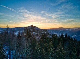 Sunset above the ruins of an old castle in the austrian alps.