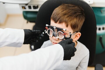 Trial frame. Glasses for a little boy. Hypermetropia. Ametropia correction with glasses.