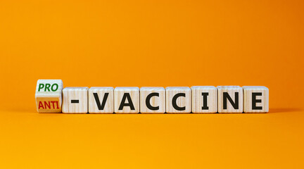 Pro-vaccine or anti-vaccine symbol. Turned a cube, changed words 'anti-vaccine' to 'pro-vaccine'. Beautiful orange background. Copy space. Medical covid-19 pro-vaccine or anti-vaccine concept.