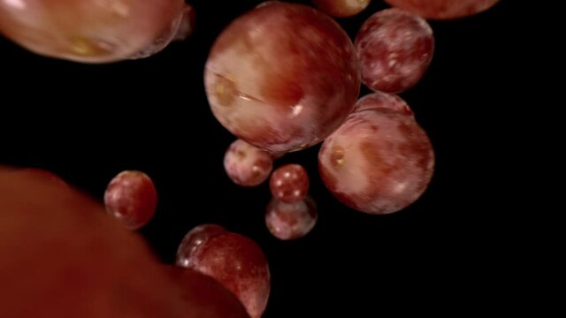 Fresh Grapes Pieces Falling on Black Background. Super Slow Motion, Wide Angle View.