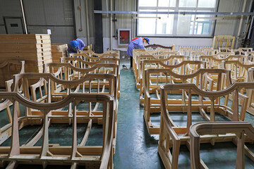 Workers are busy on the furniture production line