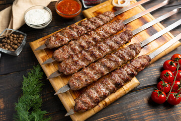 lula kebab with vegetables on cutting board