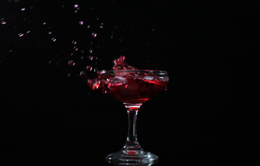 Splash drink into the glass with black background