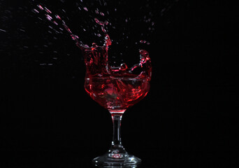 Splash drink into the glass with black background