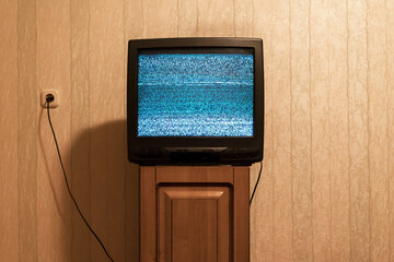 Vintage television screen with glitch analog translation on wooden tv set