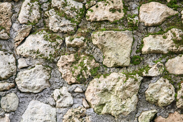 background, texture - mossy rough masonry from natural stone