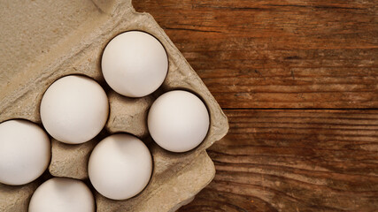 White eggs on wooden background. Easter and healthy food breakfast cooking concept