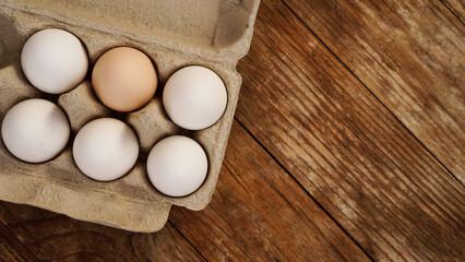 White eggs on wooden background. Easter and healthy food breakfast cooking concept