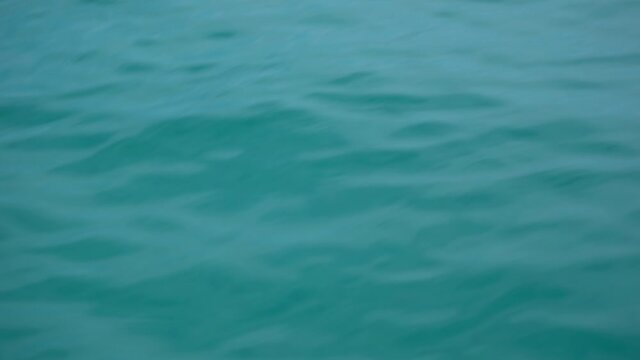 Blue water of sea as seen from moving on waves catamaran