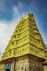 south indian temple entrance gate with blue sky background illuminated with tungsten bulb