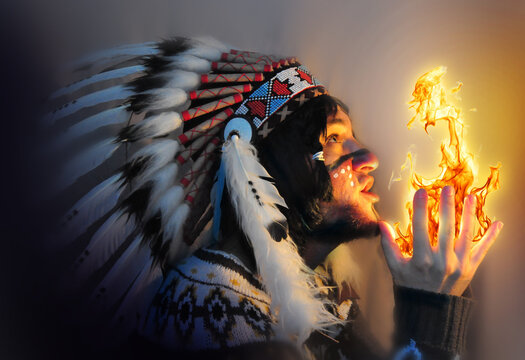 Portrait Of A Young Handsome Guy In A Hat With A Feather Of The Chief Of The Indians. Fire And Man - Portrait