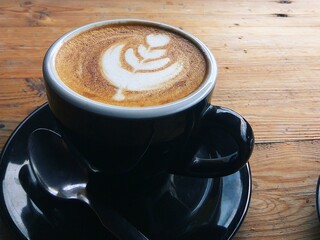 cup of coffee on wooden table