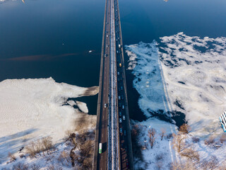 Kiev metro bridge across the Dnieper river. Aerial drone view. Winter sunny morning.