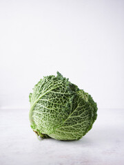 raw cabbage with closed leaves isolated on light grey surface and background