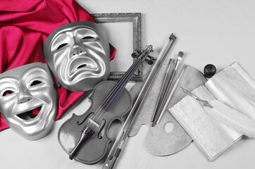 Attributes of the arts. Theatrical masks, art palette, brushes, violin, bow, pipe, fountain pen,...