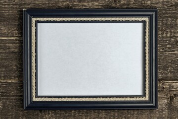 Frame in blue with white blank background on old wood texture. Copy space.