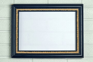 Empty old frame in blue on a white brick wall background. Copy space.