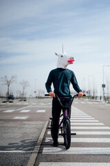 Naklejka premium unicorn man with bicycle