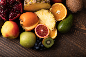 Naklejka na ściany i meble Fresh fruits and berries on wooden table