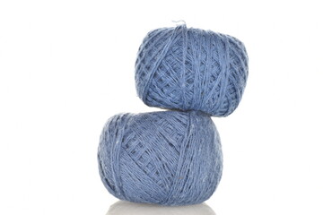 Two spools of blue thread, close-up, isolated on white.