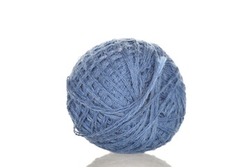 One spool of blue thread, close-up, isolated on white.