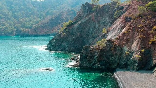 Morning on the beach in the village of Cirali. Blue bay in the Mediterranean at dawn. Landscapes of the Lycian Trail.