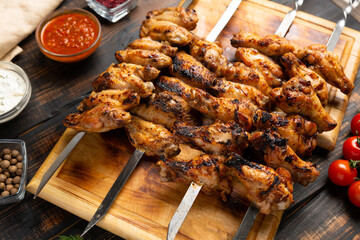 grilled or barbecue chicken wings skewer on board