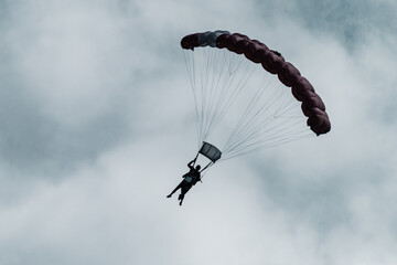 Paratrooper descending in the sky